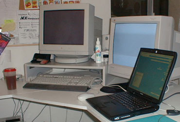 Deb's desk with Rubbermaid kid's cup by the keyboard.